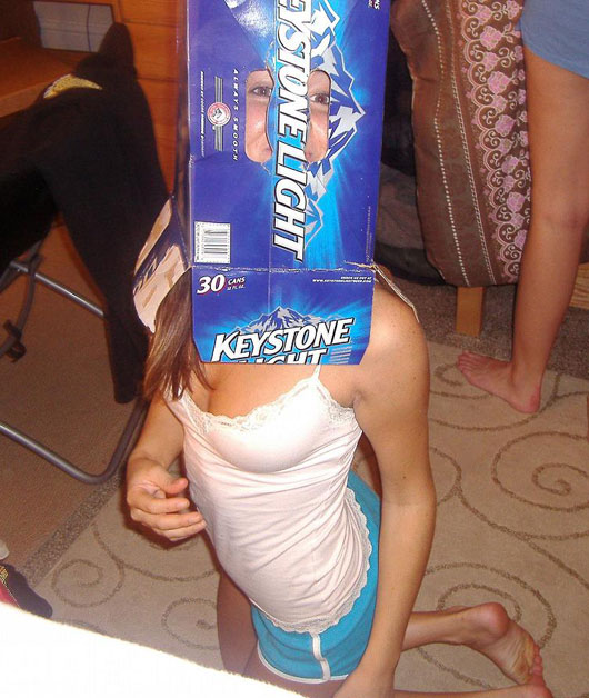 girl with empty beer container on her head