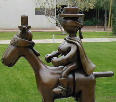 bronze sculpture of a masked man on a horse, who is also wearing a mask